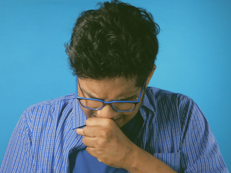 Man coughing into his hand